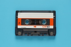 Audio cassette tape isolated on blue background, Vintage retro gadgets for The 70-80-90's