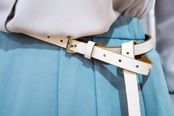 Closeup fashionable women belt on waist over skirt