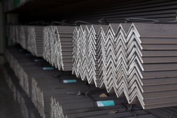 Equal Angles Steel angle iron Metal profile angle in packs at the warehouse of metal products
The arrangement of hot-dip green steel angles on the rack in warehouseMetal profile angle in packs 