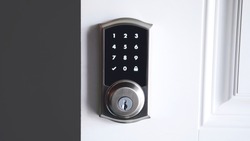 Digital smart door lock security system with the password, close up on numbers on the screen.