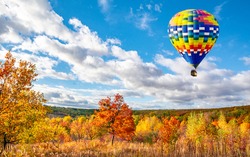 Amazing view of colorful autumn trees with hot air balloon. Concept for fall background. Artistic picture. Beauty world. 