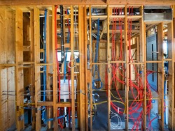 Interior wall framing with piping and wiring installed