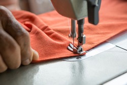 Selective focus of Sewing machine and blurred hands and copy space