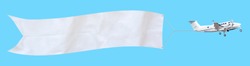 Propeller aircraft with a long white advertising banner made of fabric. Isolated on a blue background