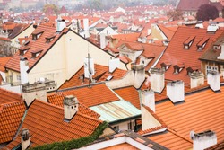 Red roof of buildings in Prague in a cold cloudy fall weather. Old town of Prague with tiled roofs. Red roofs. Europe.