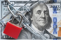 Lock and chain on cash, money restrictions, frozen assets, business finances concept