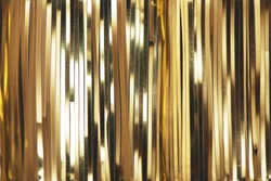 Golden foil tinsel strips. Festive decoration background