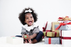 African american girl child having fun open gift box on her birthday