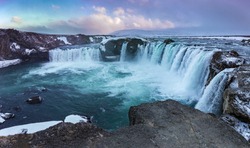 Godafoss Waterfall at sunset in a snowstorm, Northern Iceland, Europe. It is located along the country's main ring road at the junction with the Sprengisandur highland road.
