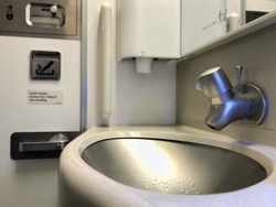 Inside the airplane toilet. Give you a chance to have privacy to wash your hands or brush your teeth. Or put on your make up, while are you up in the air.