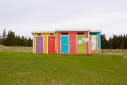Colourful outhouses along a hike in Cows Head Newfoundland. Interesting sight seeing.