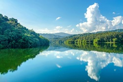 Landscape of the dam and lake on the mountain with tree and forest, The river and beautiful blue sky and clouds on sunshine day.
