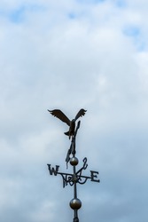 Eagle weather vane on a cloudy day