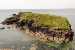 Picture of a small rocky Brown Island in Annestown Cove,County Waterford,Ireland.