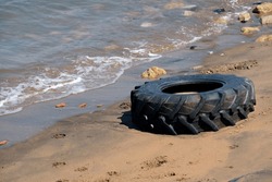 Water pollution - discarded tire at a beach in Portugal