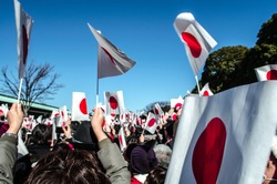 People waving Japan Flags in Emperor Birthday day at Imperial Palace in Tokyo