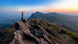 Winner man on peak of rocks mountain Hike at sunset, Active life concept