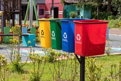 Set of bins for the selective collection of waste (metal, glass, paper, and plastic), in portuguese,  for recycling purposes.