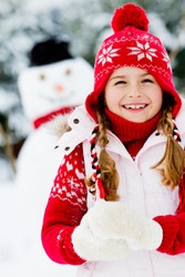 Winter, snowman - lovely girl has a fun in snow