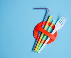 No use symbol in red with plastic straws and fork.  Plastic pollution is harmful to  marine lives. Environmental concept. Ban single use plastic campaign.