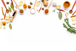 Seasoning background. Dry spices near ginger, garlic, rosemary, laurel leaf on white background top view copy space