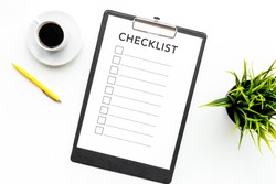 Blank checklist with space for ticks on pad on office desk. Checklist for office worker, manager, businessman, chief on white background top view