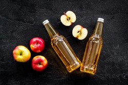 Apple cider vinegar bottle on black background top view