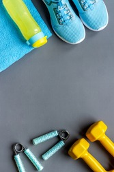 Fitness and gym equipment with sneakers and dumbbells. Sport background