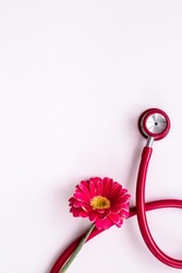 Breast cancer diagnosis with red stethoscope and flower