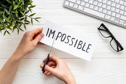 It is possible concept. Word Impossible becomes Possible with scissors