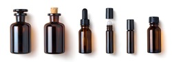 various amber glass bottles for cosmetics, natural medicine , essential oils or other liquids isolated on a white background, top view	