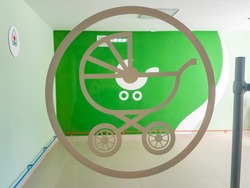 green baby carriage sign painted on scratched wooden board texture background