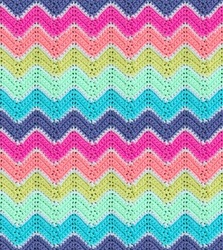 Seamless knitted pattern in the form of zigzags is crocheted with multi-colored threads. Acrylic baby yarn. Delicate light colors.