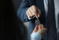 Businessman hands over house keys to client
