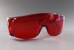 Red plastic safety glasses, protective workwear for human eyes