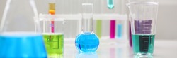 Chemical industry bulb with blue magenta pink liquid lab tubes stand on the table in the laboratory of liquid testing test development substances poisons additives stabilizers flavors house cleaning