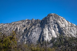 Beautiful view of majestic Tahquitz Peak on a clear sunny spring day with patches of snow remaining from the winter, Devils Slide Trail, San Jacinto Wilderness, Idyllwild-Pine Cove, California