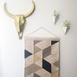 Square Woven tapestry metal bull head and plant hanger decorations against white wall