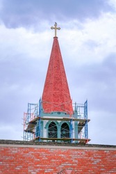 Under construction of a church spire against the cloudy sky in Silicon Valley, San Jose, CA
