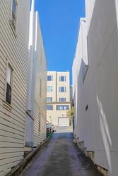 Uphill alleyway in the middle of flat residential buildings in San Francisco, California