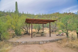Picnic table for hikers under pergola at Sabino Canyon Sate Park in Arizona. Relaxing recreation area in the Santa Catalina mountains for tourists on a hike.