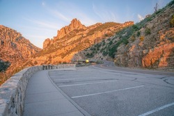 Mount Lemmon, Arizona- Scenic overlooking view of mountain landscape during sunset. Rest stop with parking spaces on the side of the road and mountain slope.