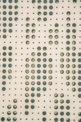 San Antonio, Texas- Beige perforated metal sheet wall. Close-up of a metal wall with decorative holes pattern creating a shadow at the background.