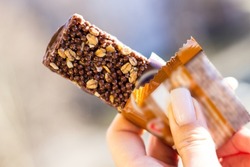 Woman holding a cereal bar