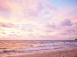 Colorful sunset on the tropical beach with beautiful sky, clouds, soft waves