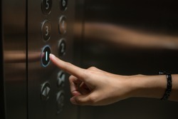 The finger is the push button of the elevator.