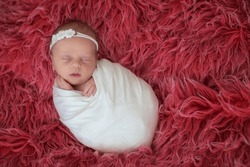 Little newborn baby girl, smiling, infant studio shot