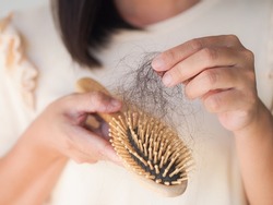 Healthcare concept.Closeup hair loss,hair fall in hairbrush stress problem of woman.