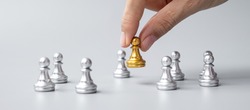 hand holding golden chess pawn pieces or leader businessman with of silver men. victory, leadership, business success, team, recruiting, and teamwork concept
