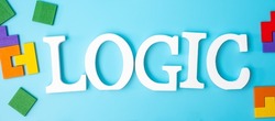 LOGIC text with colorful wood puzzle pieces, geometric shape block on blue background. Concepts of logical thinking, Conundrum, solutions, rational, strategy, world logic day and Education